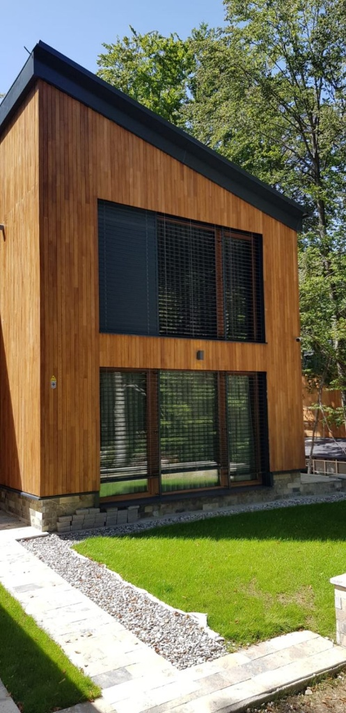 Modern exterior vertical timber cladding on a contemporary two-storey building